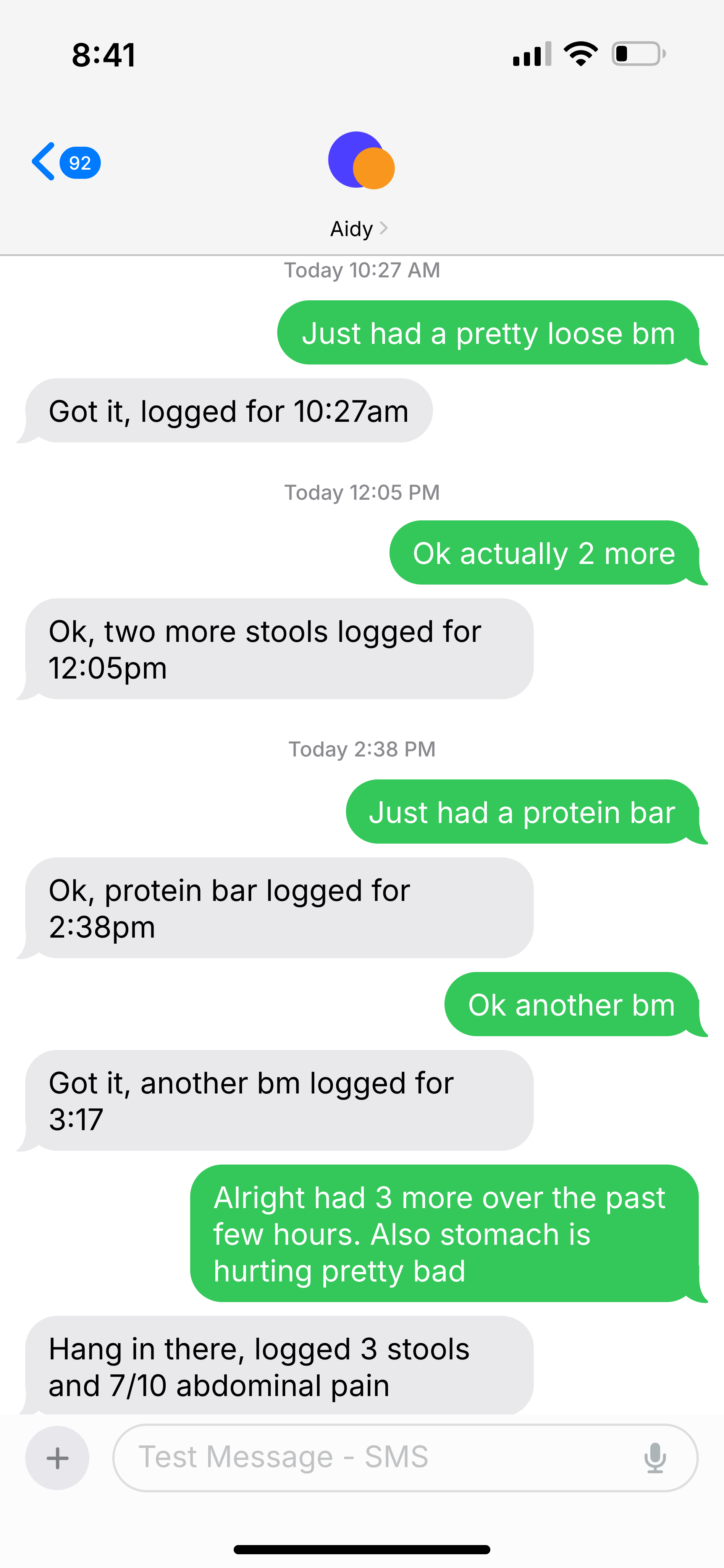 Text conversation with Aidy logging symptoms over SMS